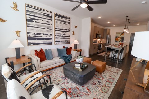 The Wren 1 bedroom model apartment home living space with ceiling fan located in Lawrenceville, GA